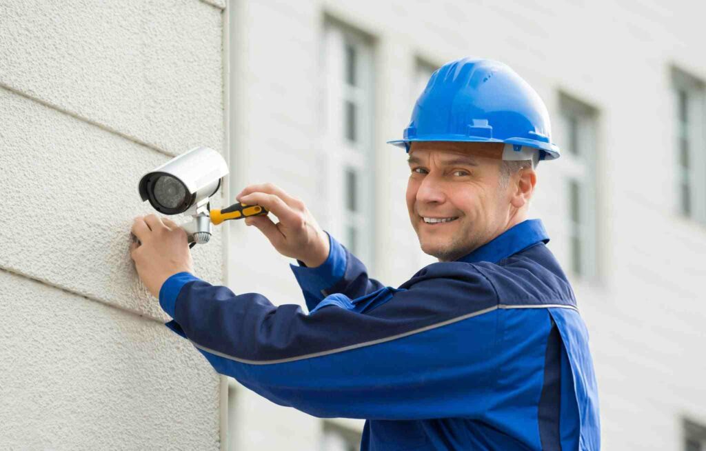 Technician installing a CCTV camera