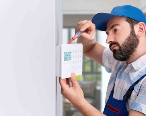 Alarm system, access control system, technician installing keypad, smart security solutions Melbourne, home and commercial security installation Alarm system installation