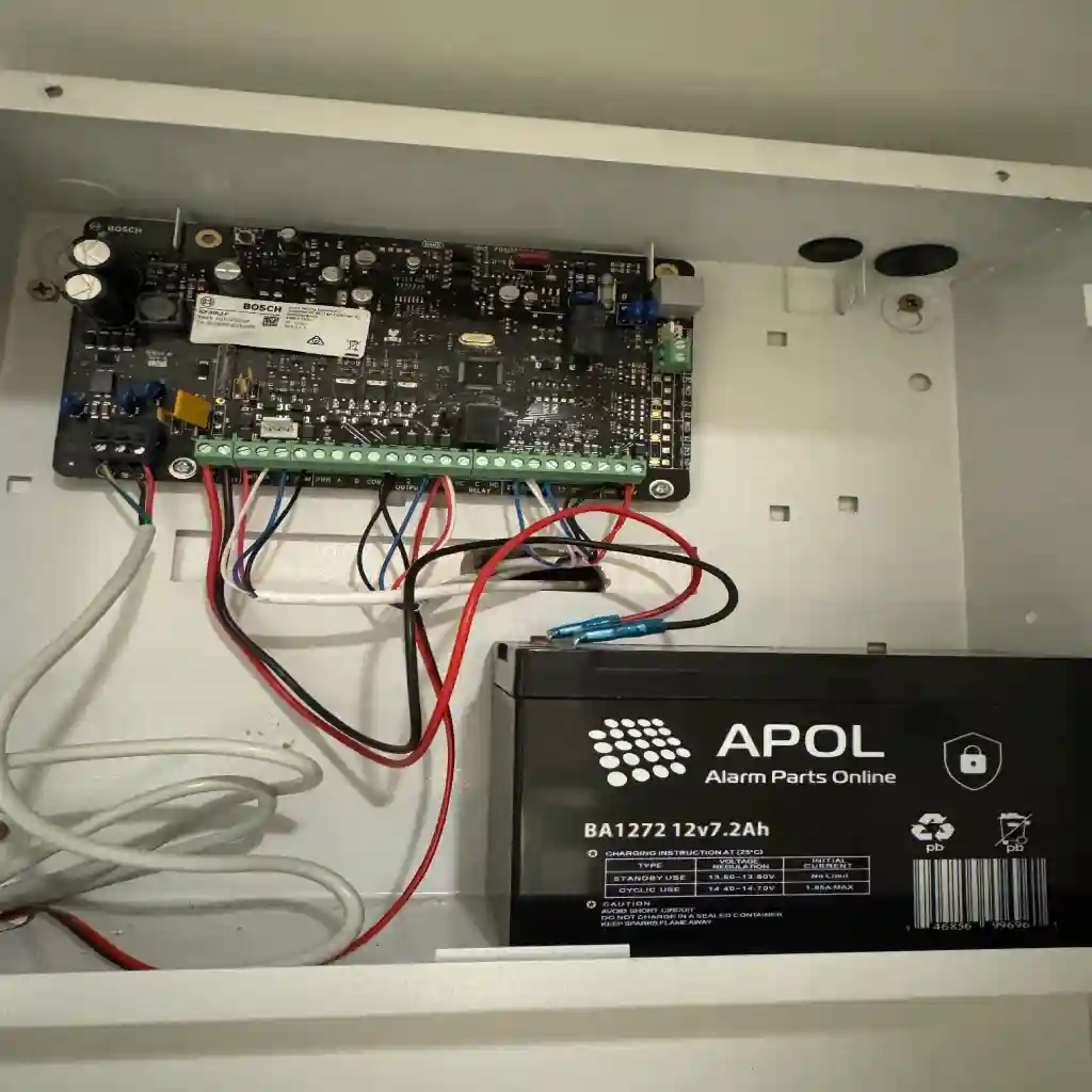 Alarm board and backup battery wired on a large block install