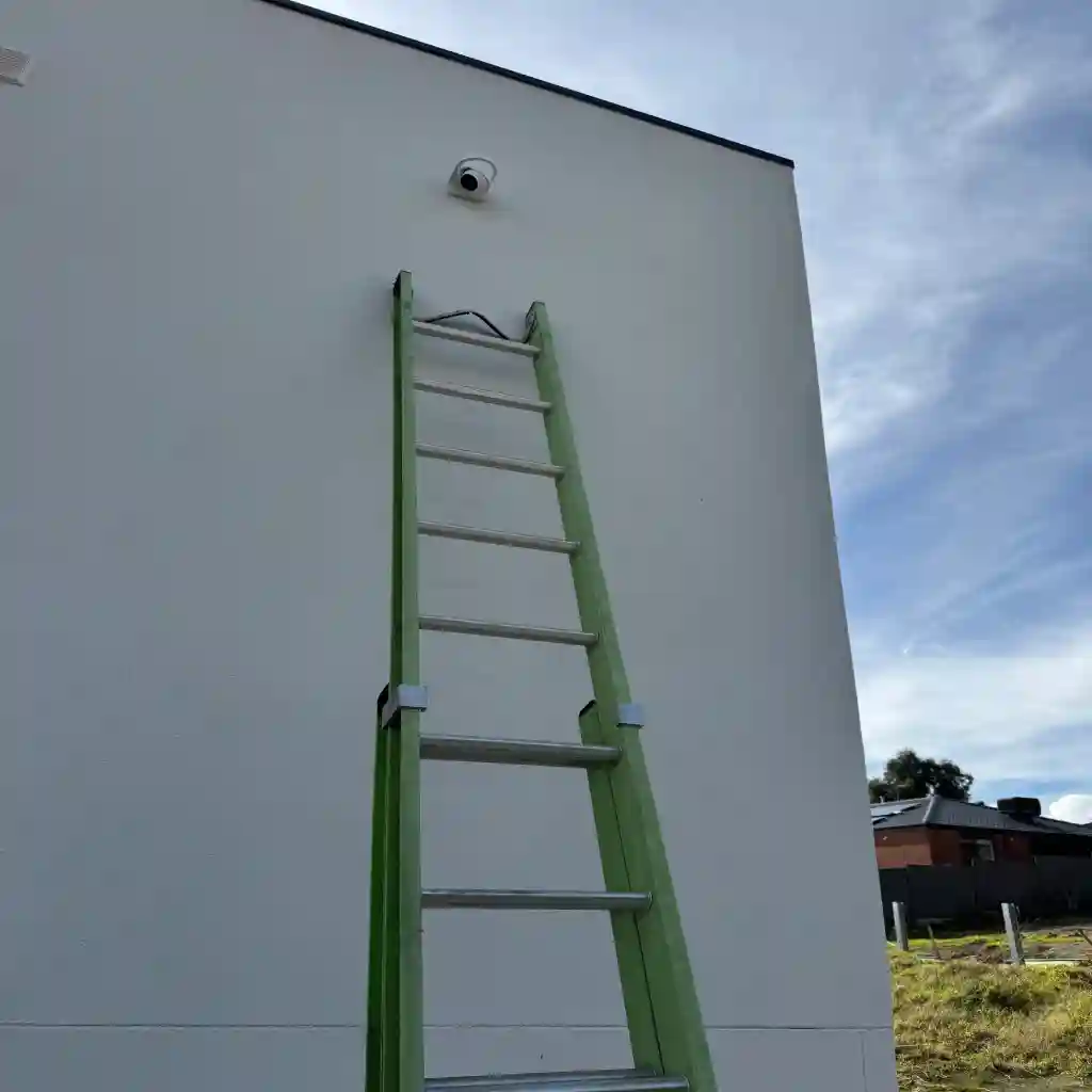 Turret camera fitted high on a wall at a commercial property