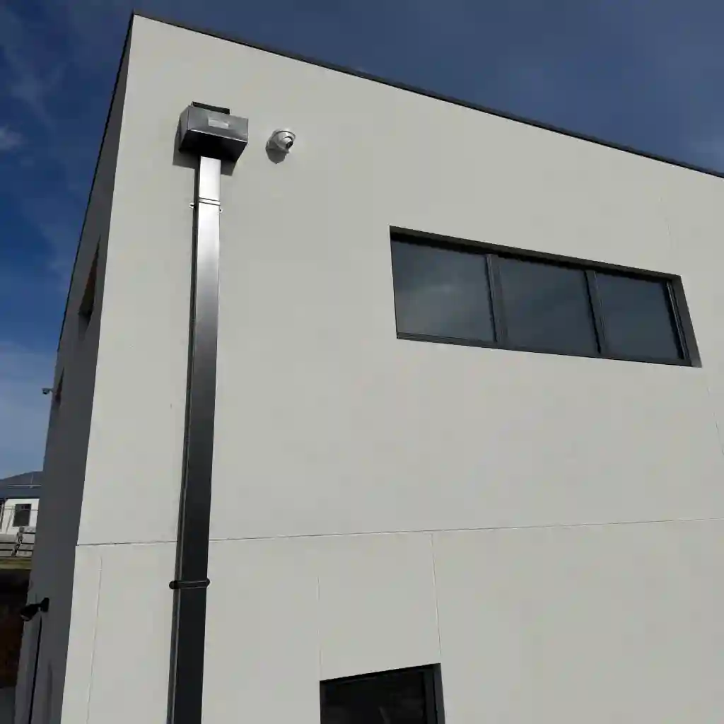 Security camera and conduit fitted at the corner of a Melbourne commercial building