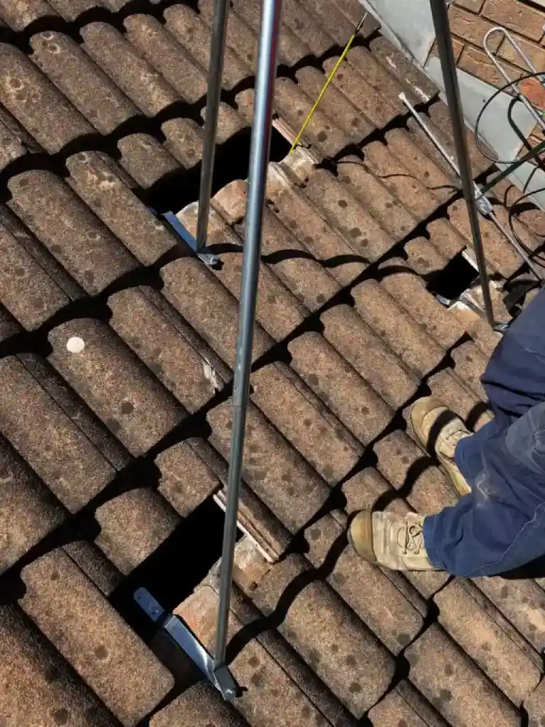 Dish and aerial mounts fitted through a tiled roof on a farm