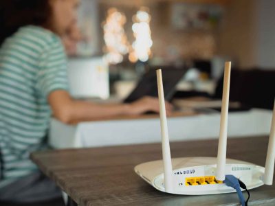 Modern Wi-Fi router setup in a Melbourne home office with a technician ensuring strong signal coverage. Borderless Solutions offers expert Wi-Fi setup, optimization, and troubleshooting for homes and businesses in Melbourne.